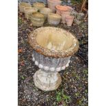 A WEATHERED COMPOSITE GARDEN URN with fluted detail to bowl height 63cm constructed in two pieces