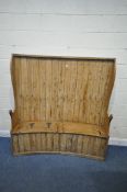 A 19TH CENTURY PINE CURVED HALL SETTLE, with later elm ends and top rail, fitted with two hinged