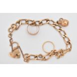 A 9CT GOLD CHARM BRACELET, a curb link bracelet fitted with a heart padlock clasp, hallmarked 9ct