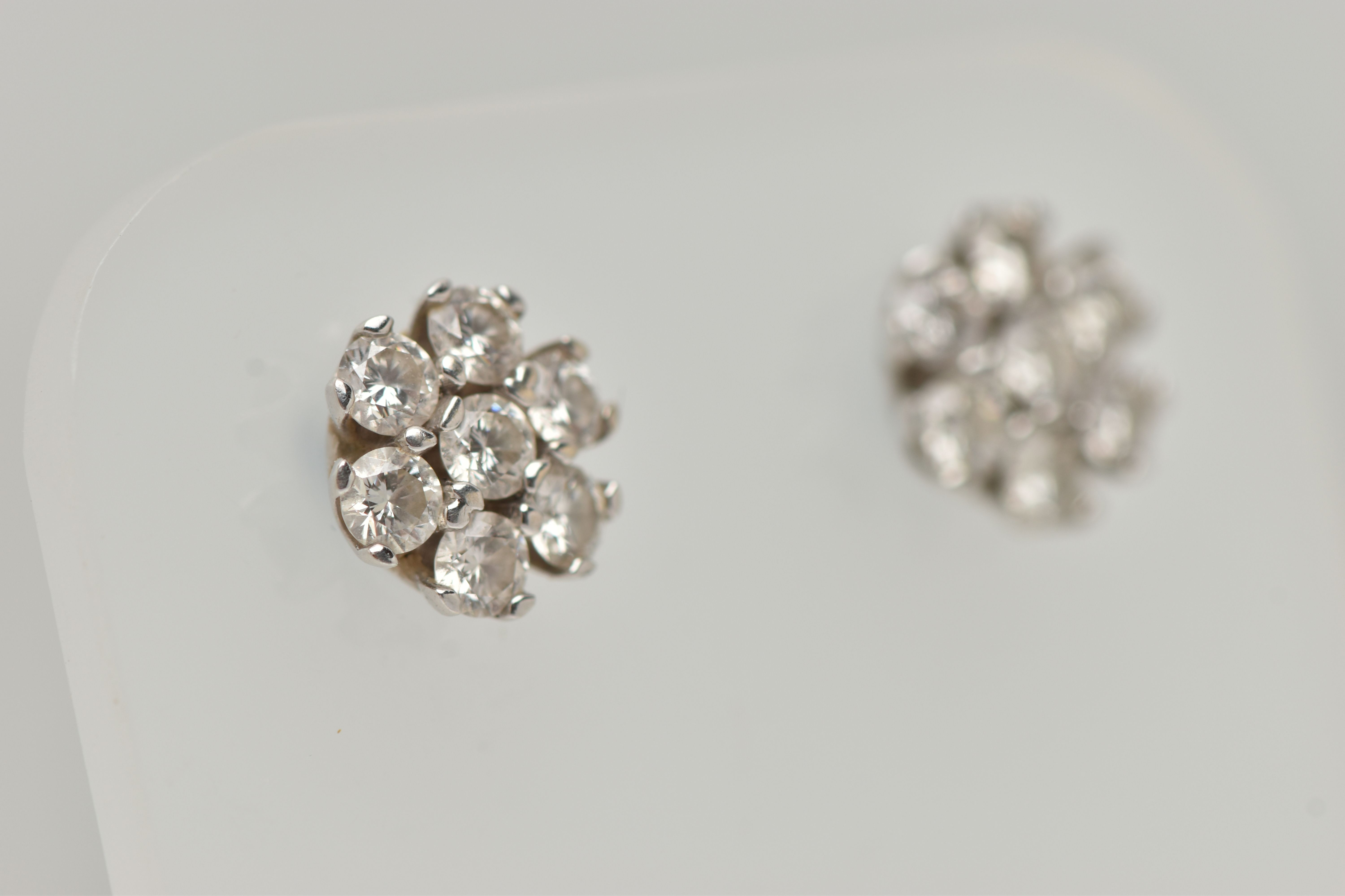 A PAIR OF WHITE METAL DIAMOND CLUSTER EARRINGS, each of a flower shape, set with seven round - Image 5 of 5