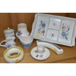 EIGHT PIECES OF POOLE POTTERY, all with floral decoration, including an hors oeuvres dish, an eggcup