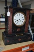 A VICTORIAN BLACK SLATE MANTLE CLOCK, inset with red marble accents, the enamel dial marked