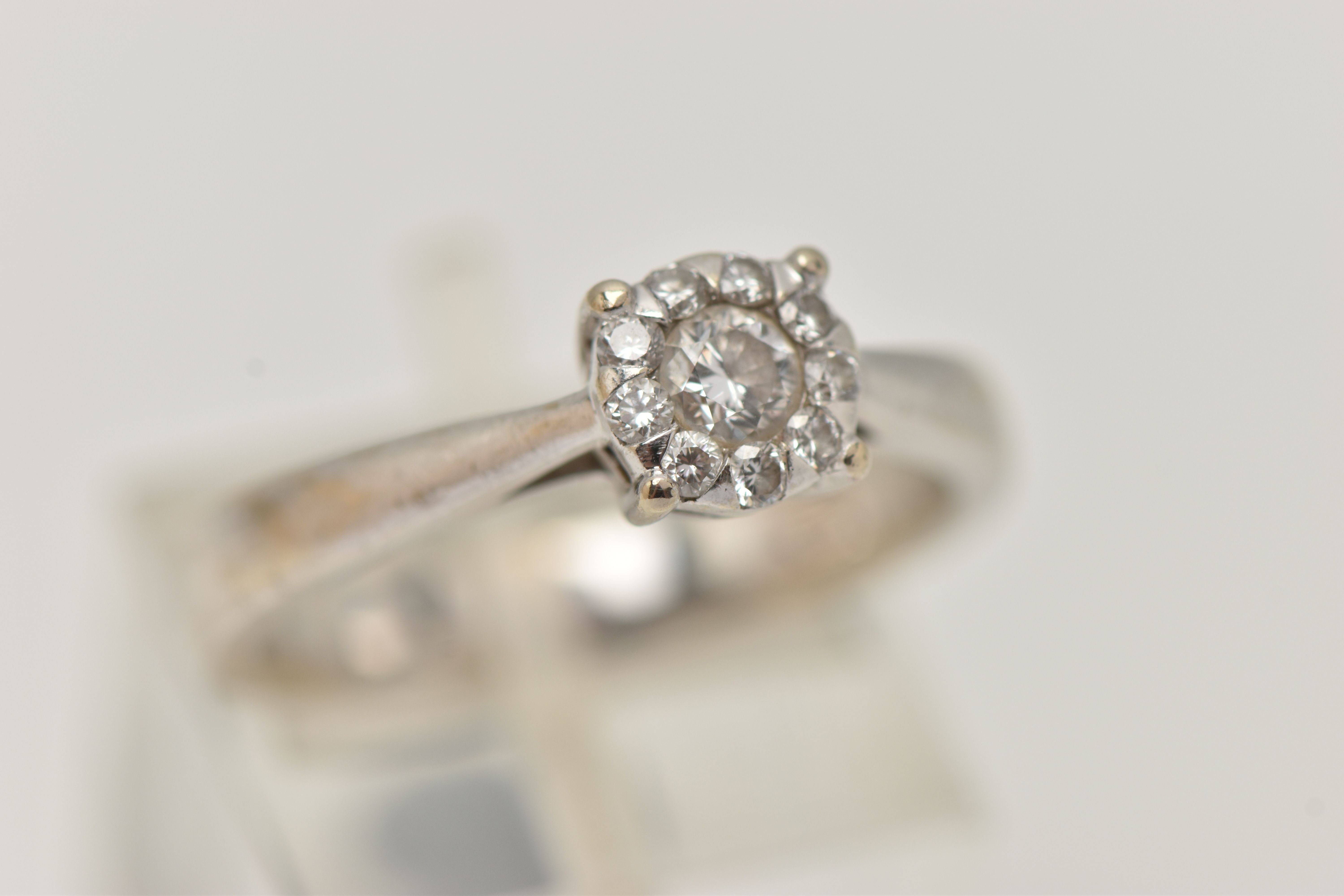 A WHITE METAL DIAMOND CLUSTER RING, centrally set with a round brilliant cut diamond, in a - Image 4 of 4