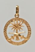 A YELLOW METAL PENDANT, of a circular open work form, depicting a palm tree and two swords, with a