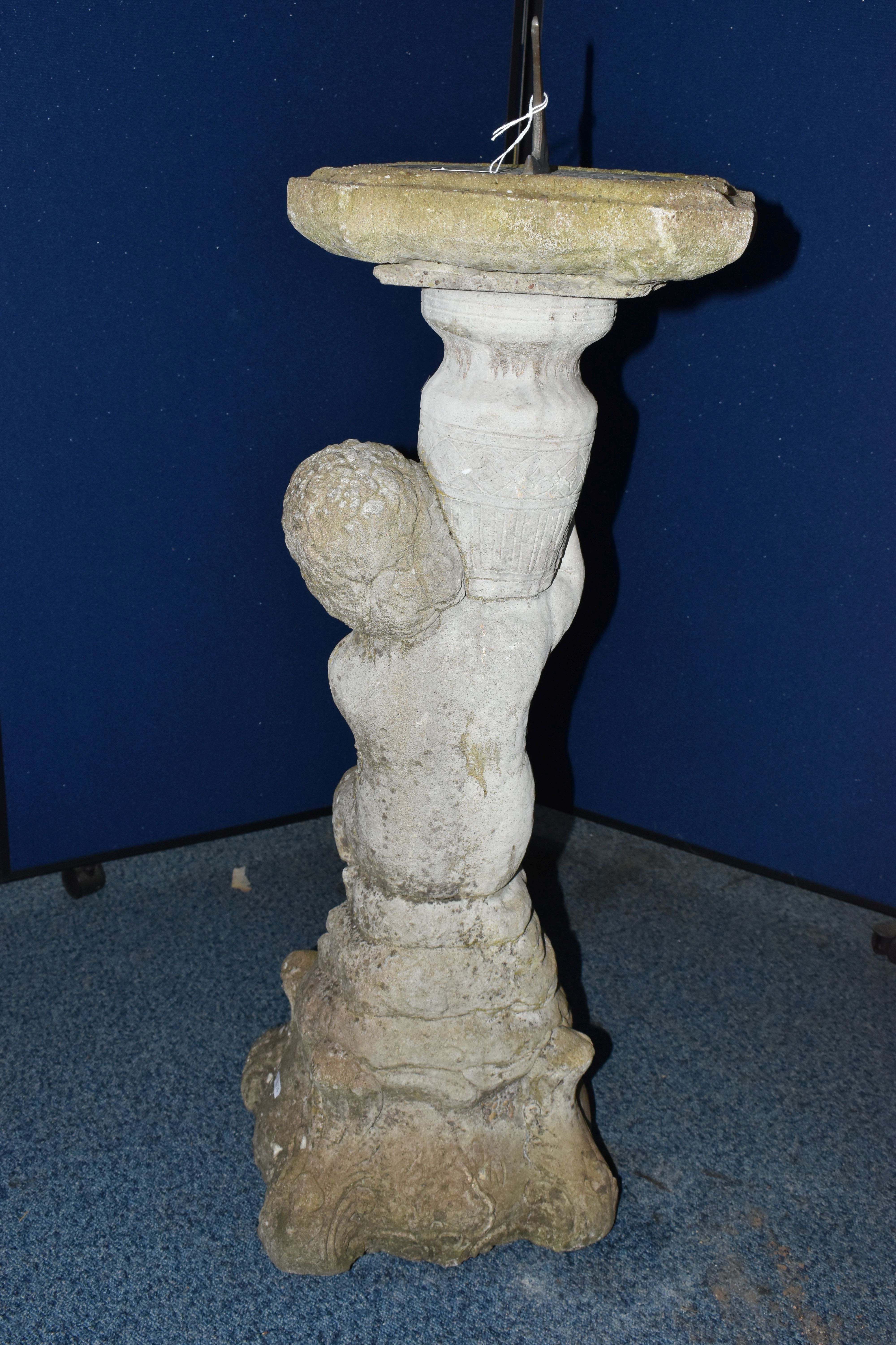 A WEATHERED COMPOSITE SUN DIAL, the top is raised on a seated putti holding an urn aloft, diameter - Image 8 of 10