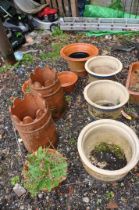 A COLLECTION OF NINE GARDEN POTS including a pair of terracotta chimney pots 47cm high, a pair of