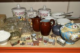 A COLLECTION OF JELLY MOULDS AND LIMOGES SAUCEPANS, comprising five clear glass jelly moulds, a late