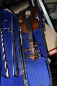 A CASED VIOLIN, two piece back, ebonized fingerboard, in a hard fitted case with two bows - one