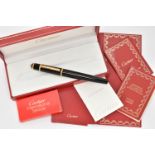 A BOXED 'CARTIER' FOUNTAIN PEN, black resin body with yellow metal collar signed 'Cartier', set with