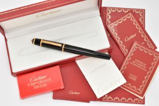 A BOXED 'CARTIER' FOUNTAIN PEN, black resin body with yellow metal collar signed 'Cartier', set with