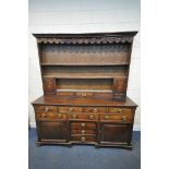 A GEORGIAN OAK DRESSER, the two sections with a three tier plate rack, two doors and a single