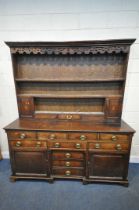 A GEORGIAN OAK DRESSER, the two sections with a three tier plate rack, two doors and a single