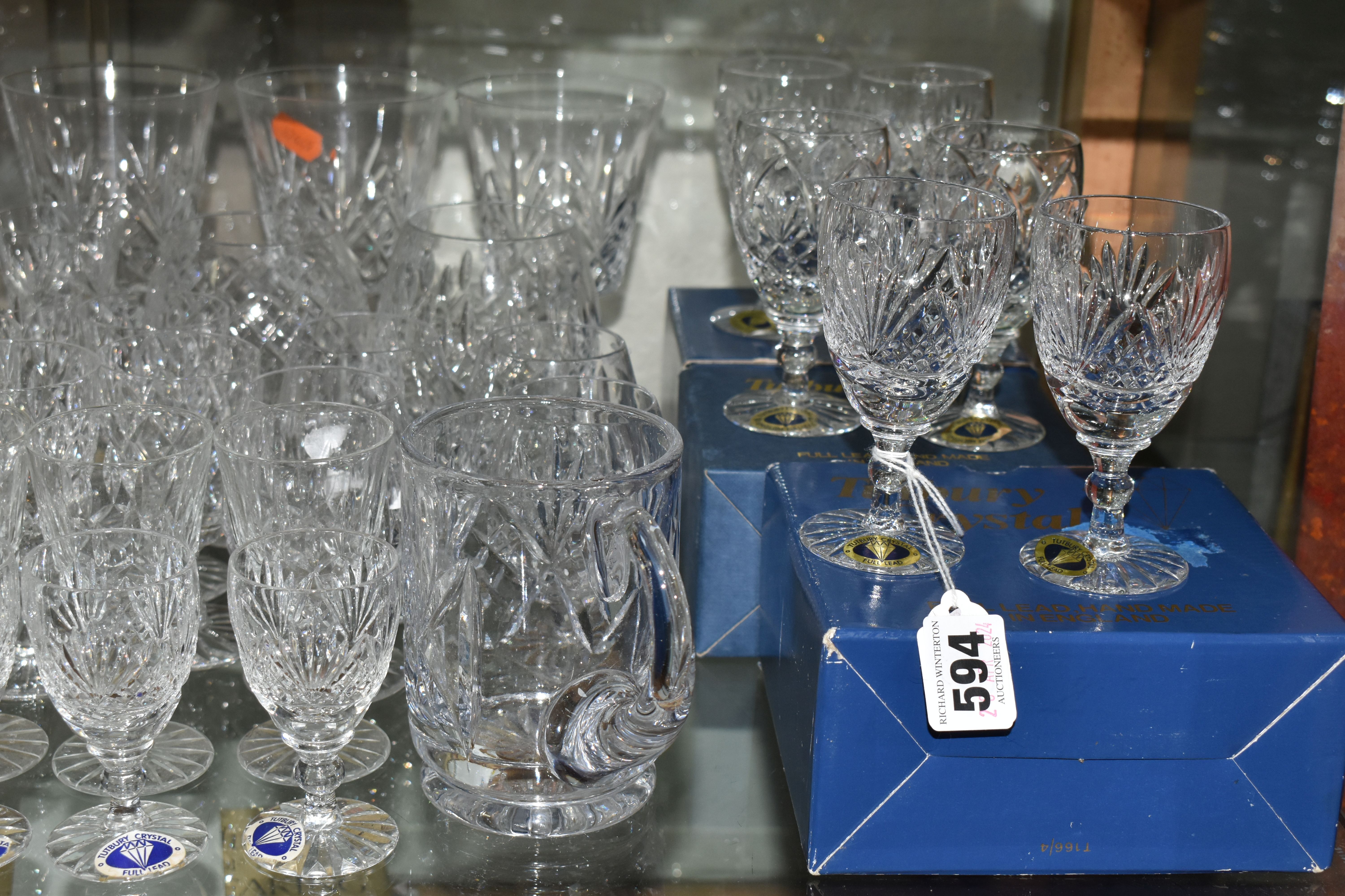 A LARGE QUANTITY OF ASSORTED CUT CRYSTAL DRINKING GLASSES, comprising Tutbury Crystal whisky