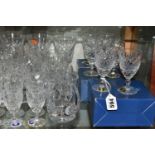 A LARGE QUANTITY OF ASSORTED CUT CRYSTAL DRINKING GLASSES, comprising Tutbury Crystal whisky