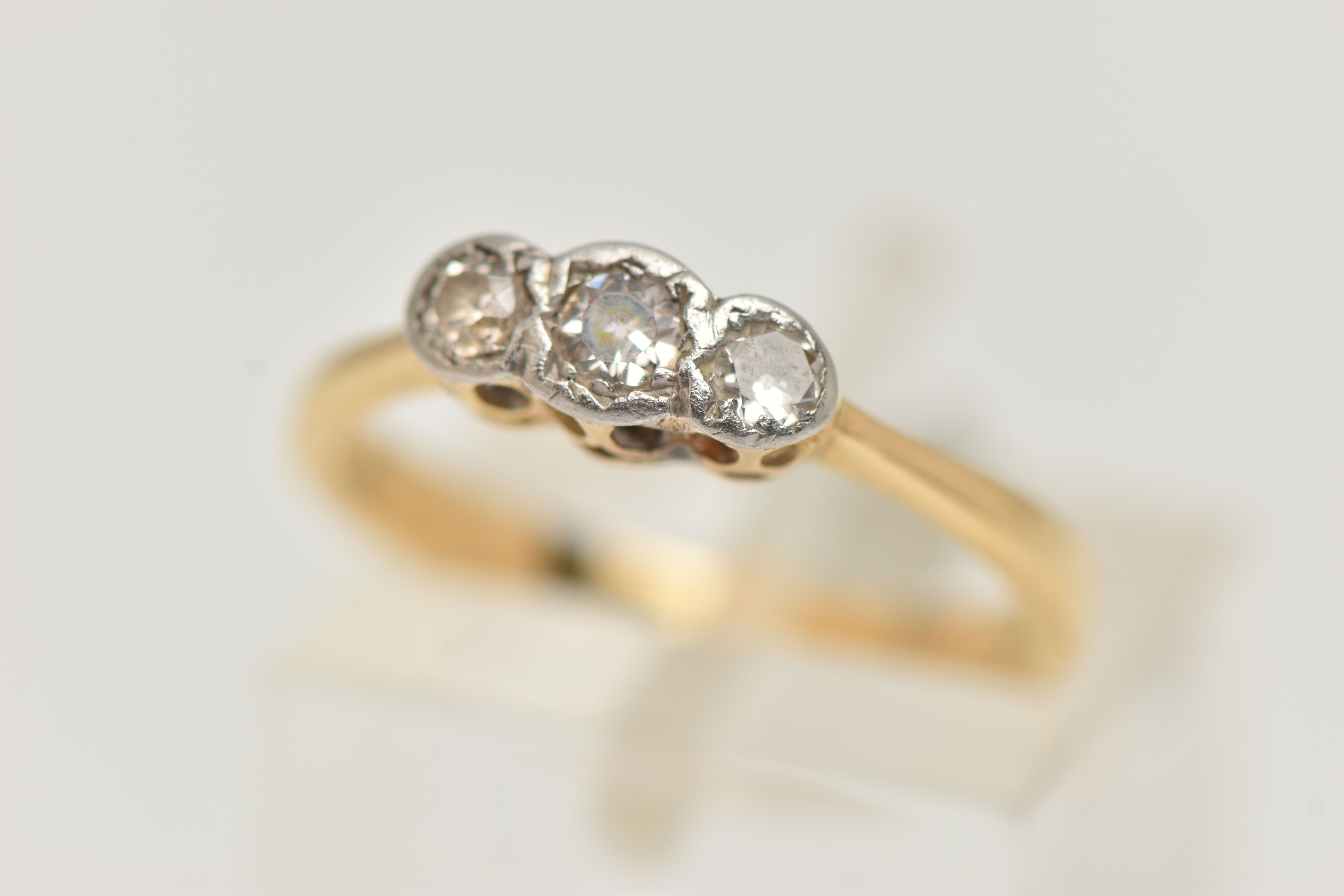 A DIAMOND THREE STONE RING, set with graduating transition cut diamonds, measuring from