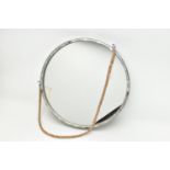 A MODERN CIRCULAR WALL MIRROR WITH GALVANISED METAL EFFECT FRAME AND ON A COARSE ROPE HANGER,