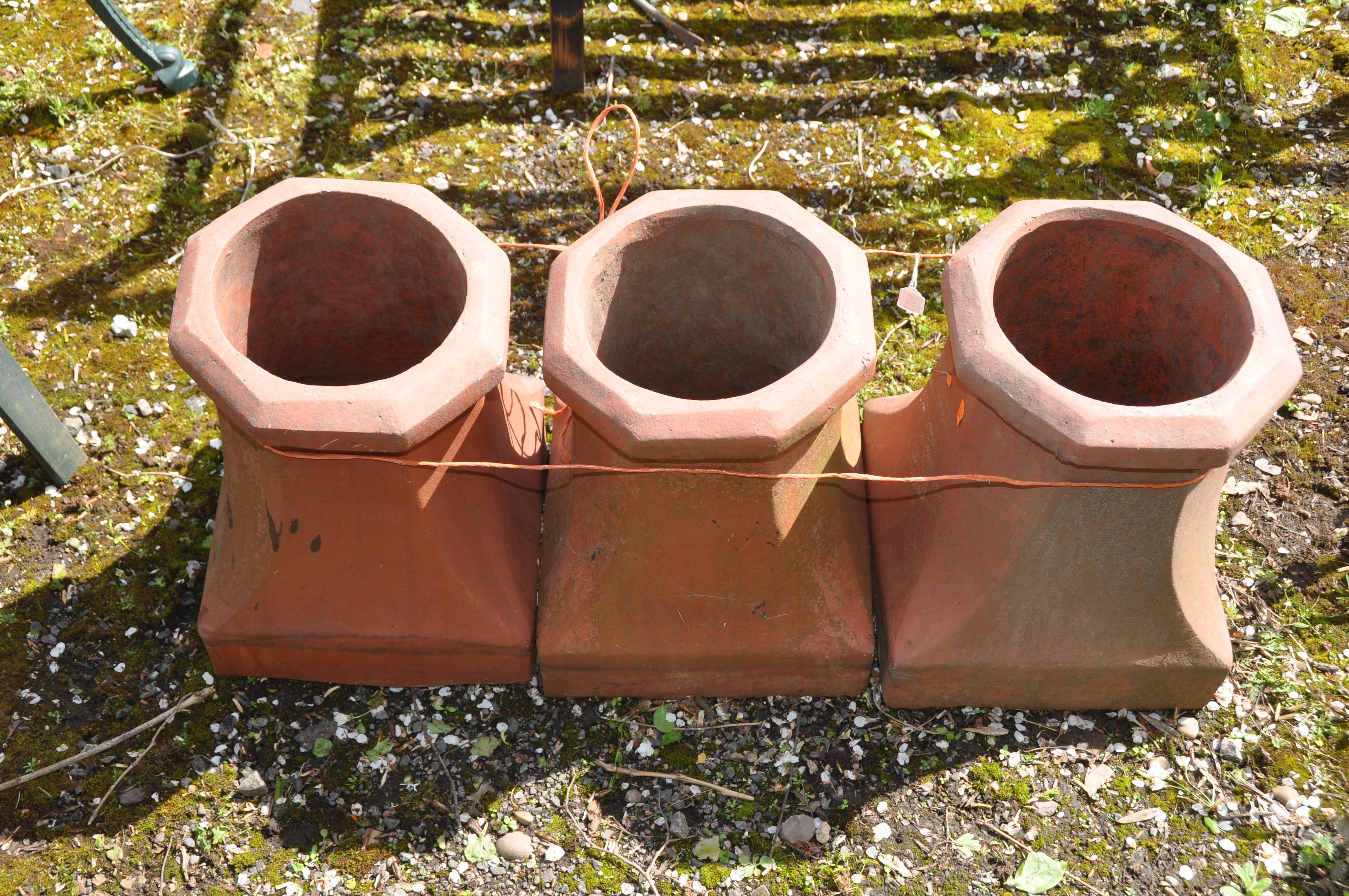 THREE TERRACOTTA CHIMNEY POTS with a square foot tapering to an octagonal rim, height 40cm - Image 2 of 2