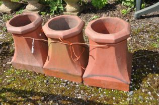 THREE TERRACOTTA CHIMNEY POTS with a square foot tapering to an octagonal rim, height 40cm