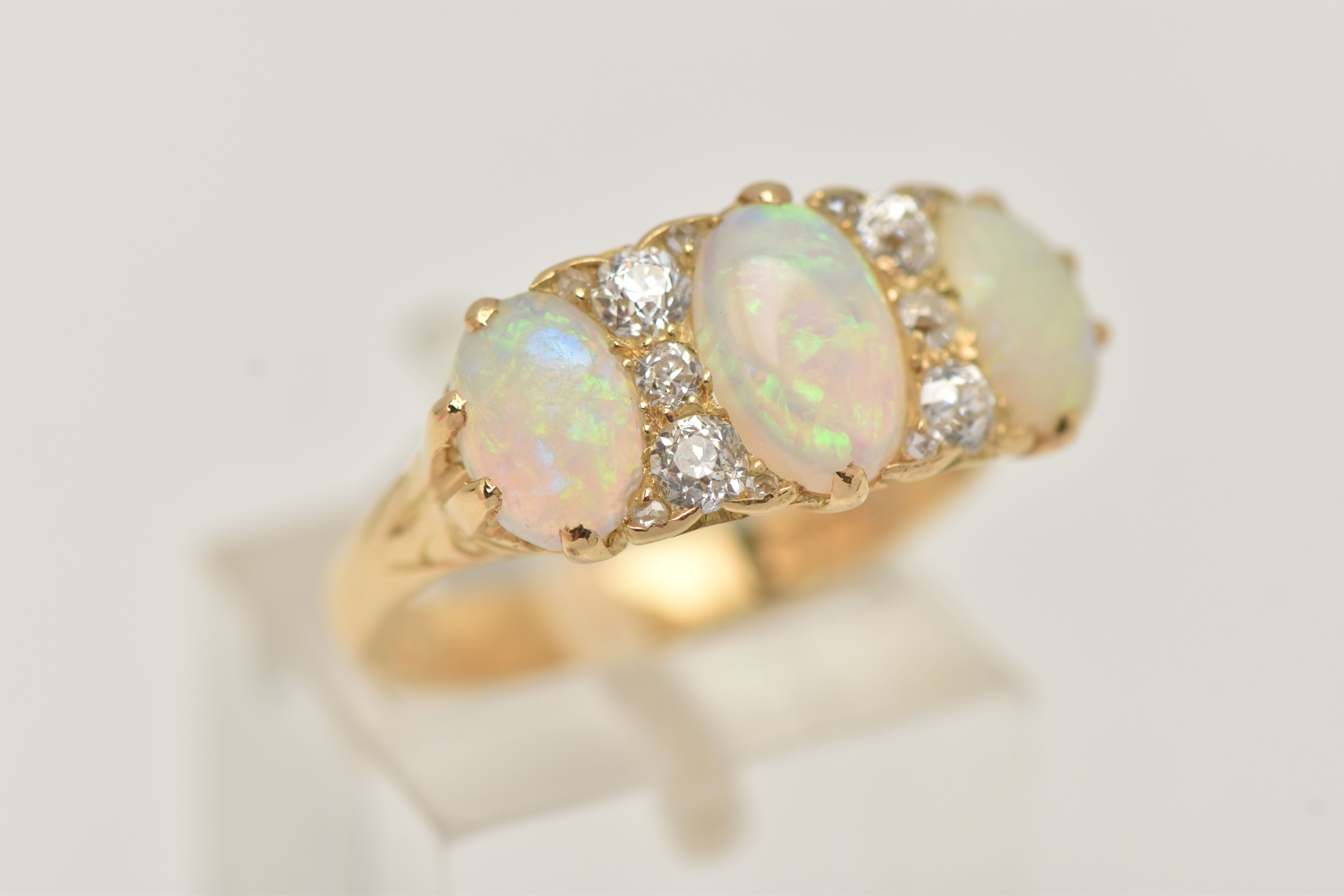 AN EARLY 20TH CENTURY OPAL AND DIAMOND RING, set with graduating oval opal cabochons, measuring from - Image 4 of 4