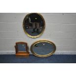 A GILT FRAMED OVAL BEVELLED EDGE WALL MIRROR, 80cm x 61cm, another gilt framed wall mirror and a