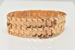 A WIDE ITALIAN BRACELET, designed as articulated geometric links to the push piece clasp with figure