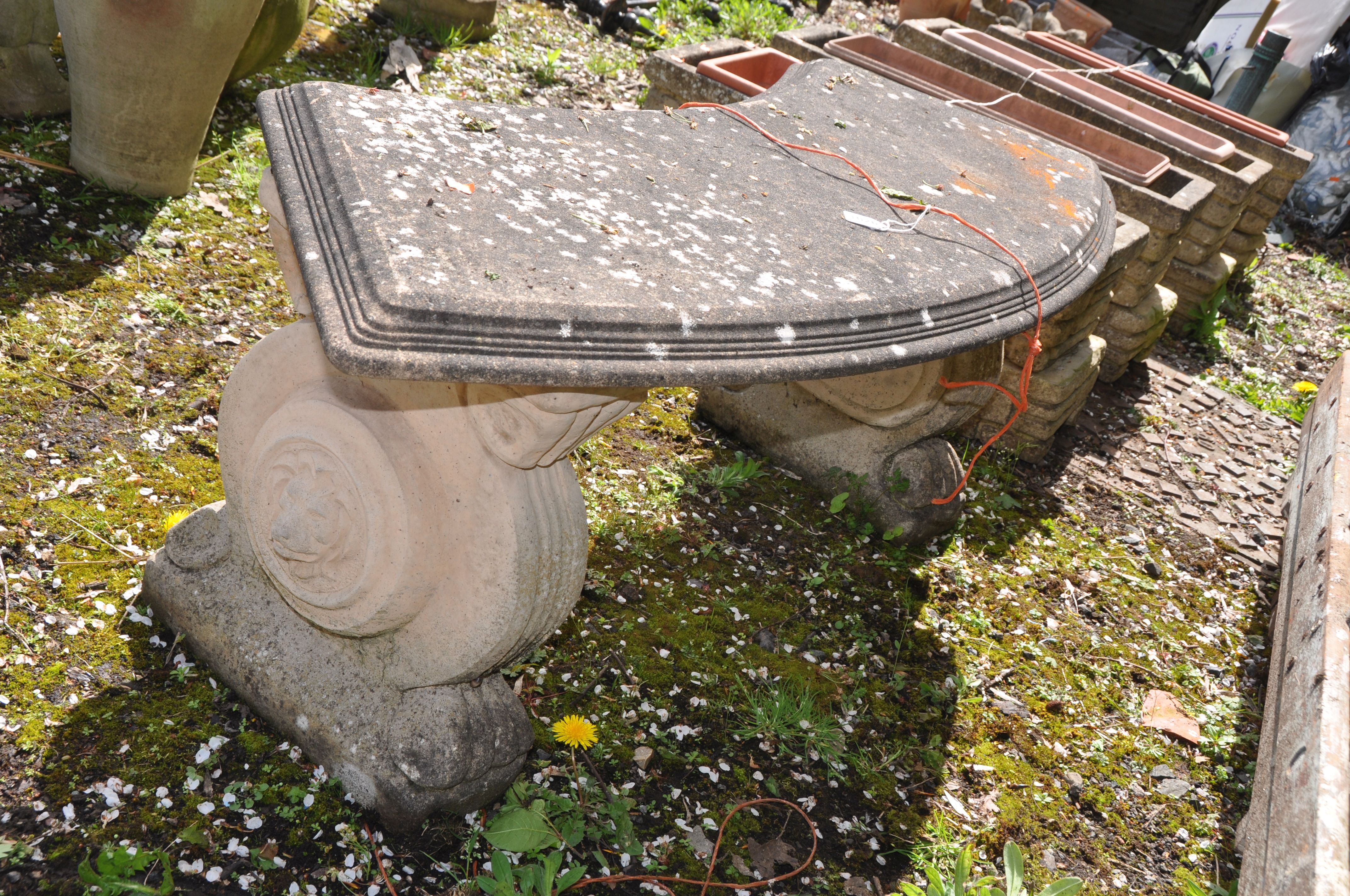 A WEATHERED COMPOSITE CURVED GARDEN BENCH with lion head motifs to each base 123cm long (condition - Image 2 of 2