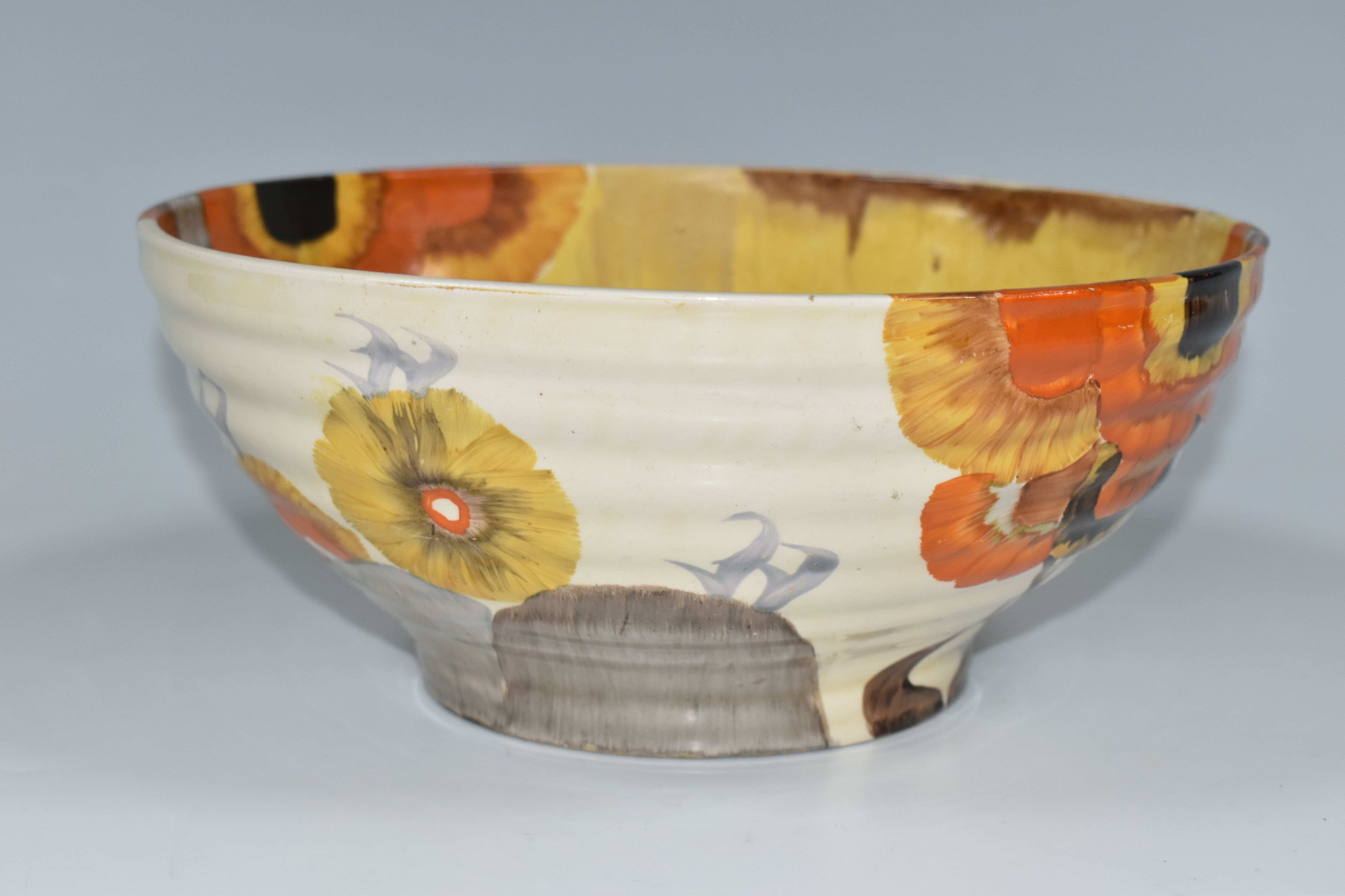 A CLARICE CLIFF BIZARRE BOWL, in Rhodanthe pattern, the ribbed bowl painted with flowers in autumnal