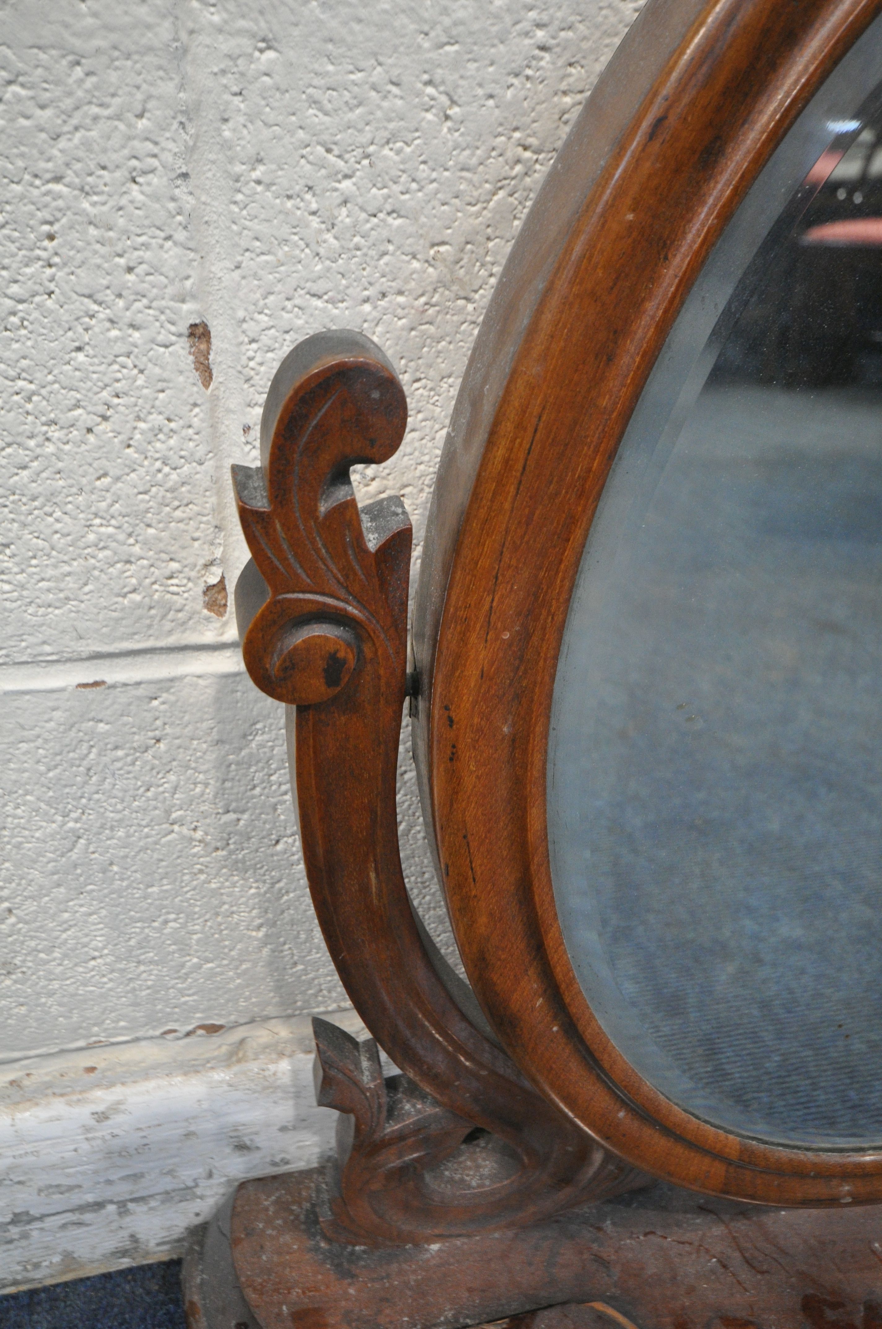 A VICTORIAN MAHOGANY TOILET MIRROR, the oval frame encasing a bevelled mirror plate, scrolled - Image 3 of 6