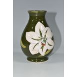 A MOORCROFT POTTERY 'BERMUDA LILY' PATTERN BALUSTER VASE, tube lined with white lilies on a green