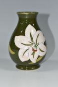 A MOORCROFT POTTERY 'BERMUDA LILY' PATTERN BALUSTER VASE, tube lined with white lilies on a green