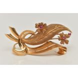 A YELLOW METAL GEM SET FLORAL SPRAY BROOCH, set with three circular mixed cut synthetic rubies, to