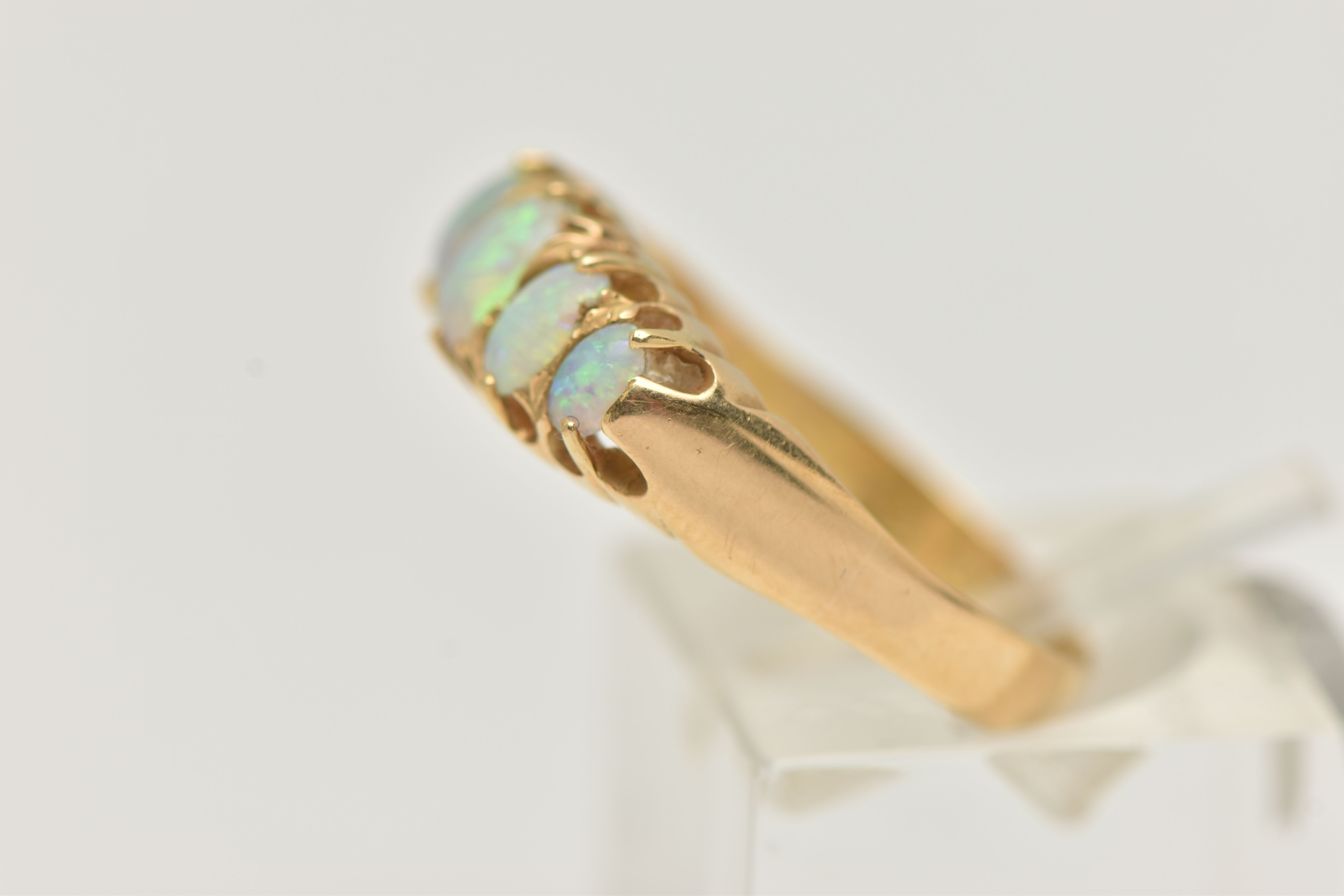 AN EARLY 20TH CENTURY, 18CT GOLD OPAL FIVE STONE RING, set with five graduated oval cut, opal - Image 2 of 4