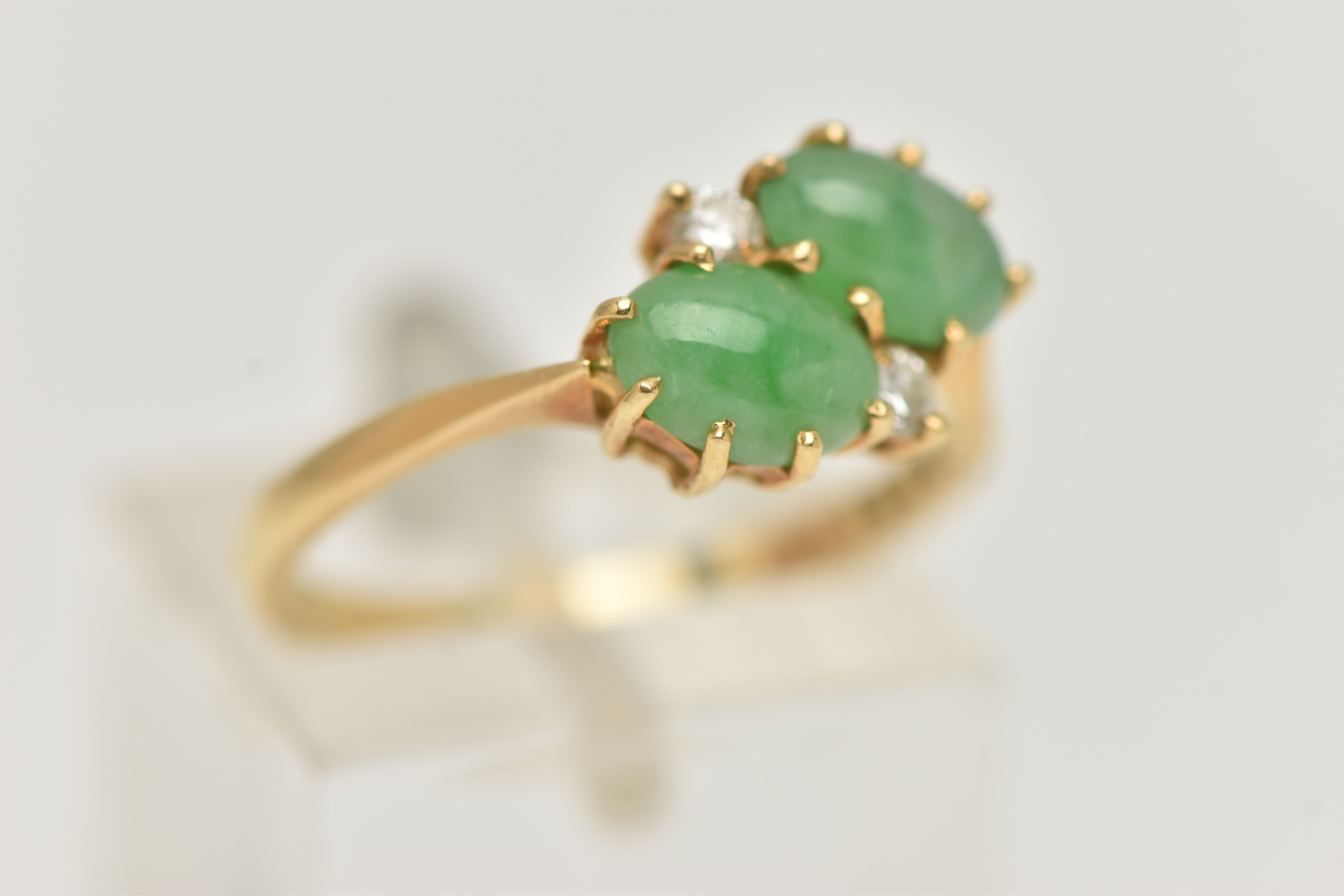 AN 18CT GOLD JADE AND DIAMOND RING, of crossover design, claw set horizontally with two oval jade - Image 4 of 5