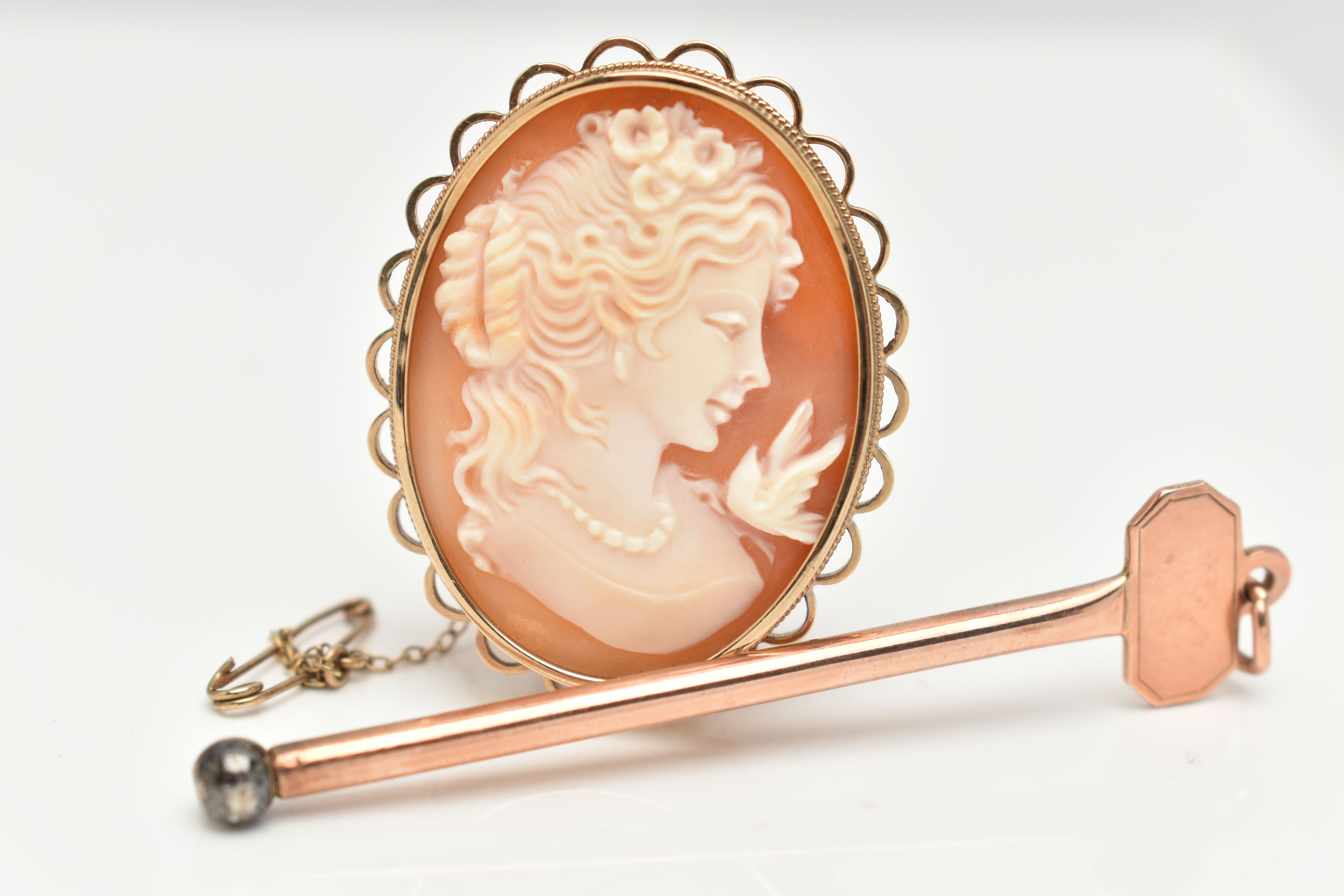 A 9CT GOLD CIGAR PIERCER AND A CAMEO BROOCH, a rose gold key fitted with a metal removeable screw,