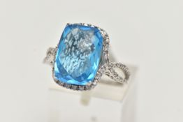 A 'KALLATI' TOPAZ AND DIAMOND DRESS RING, a large rectangular cut blue topaz, approximate length