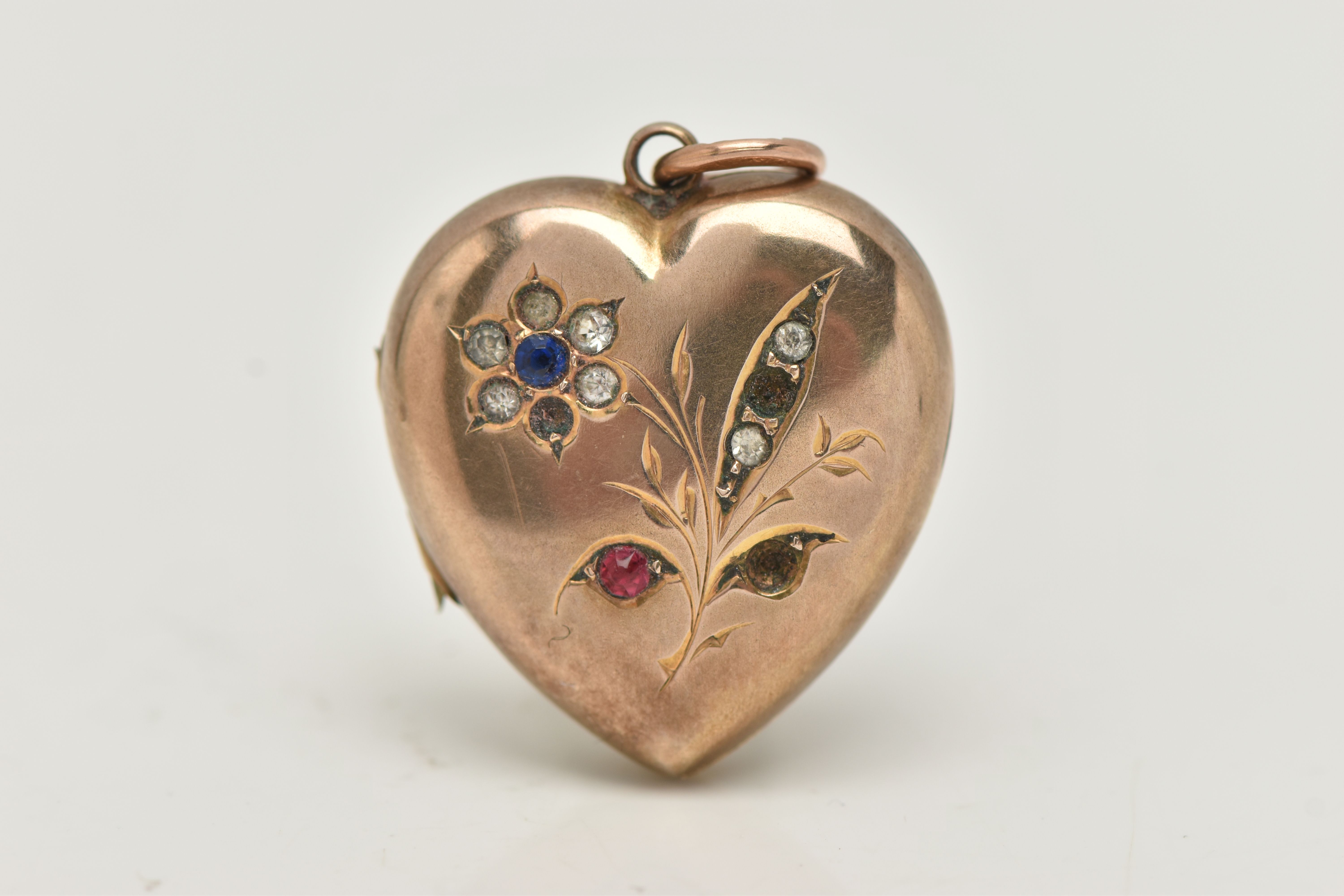 A YELLOW METAL HEART LOCKET PENDANT, floral pattern set with blue, red and colourless paste,