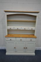 A MODERN PARTIALLY PAINTED PINE DRESSER, the top two tier plate rack and four drawers, atop a base