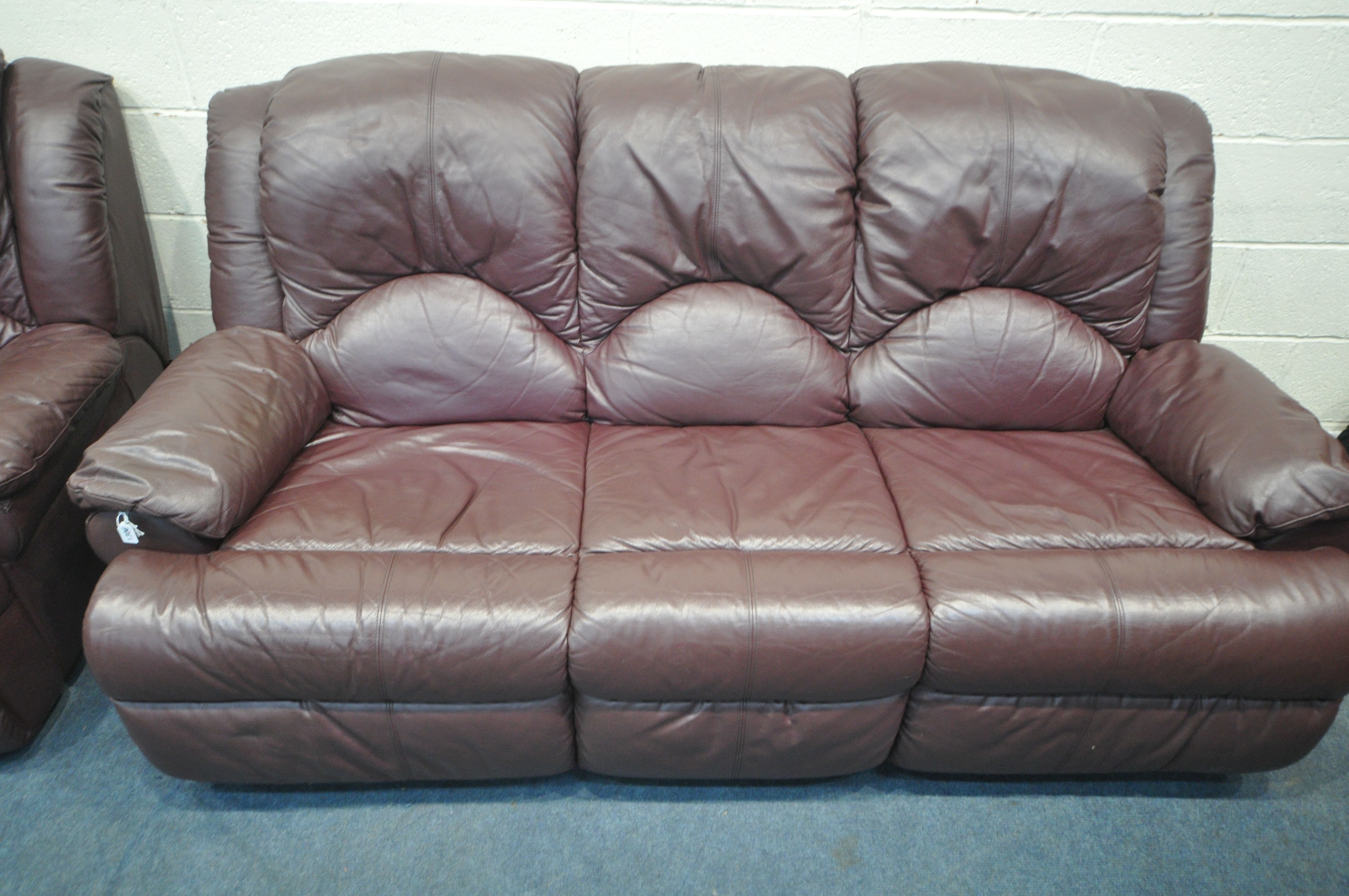 A PLUM LEATHER UPHOLSTERED THREE PIECE LOUNGE SUITE, comprising a three seater sofa, length 203cm - Image 2 of 4