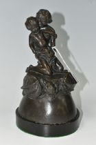 A BRONZE FIGURE GROUP, depicting a mother and child kneeling on top of a mythical beast, loose on