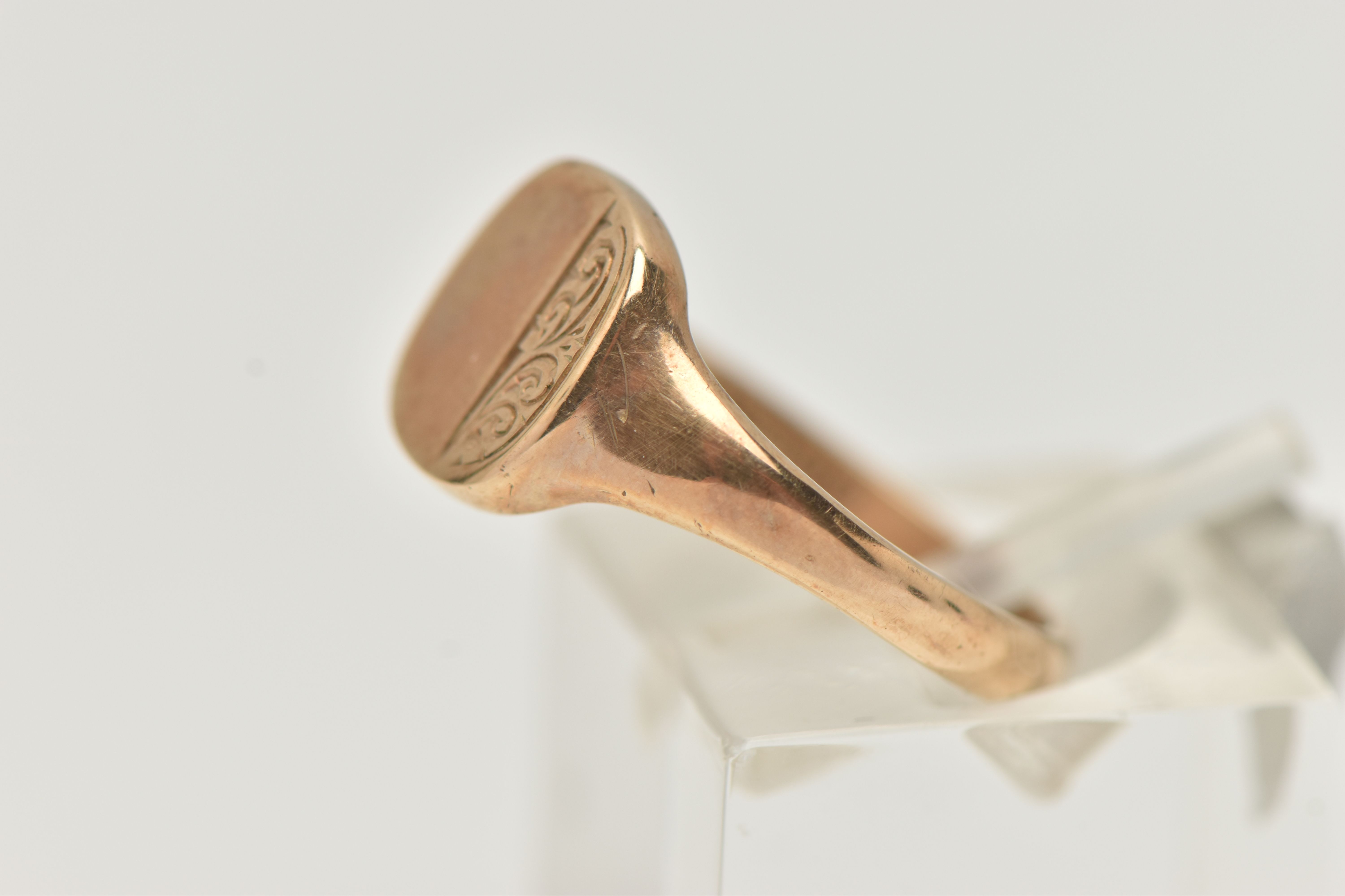 A 9CT GOLD SIGNET RING, rounded square form, with foliate pattern, tapering polished band, - Image 2 of 4