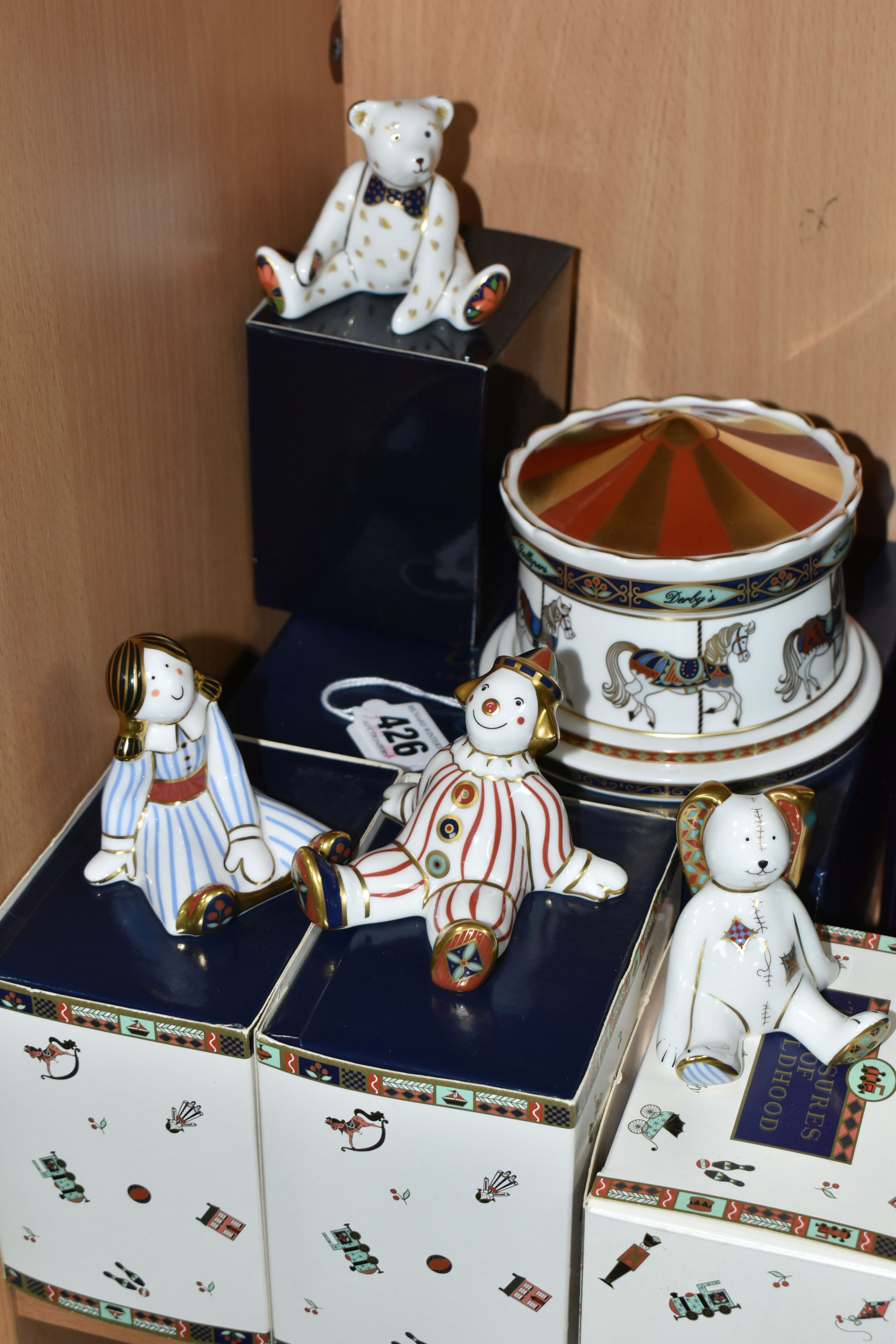 A GROUP OF BOXED ROYAL CROWN DERBY PAPERWEIGHTS AND MONEY BOX, comprising a 'Treasures of