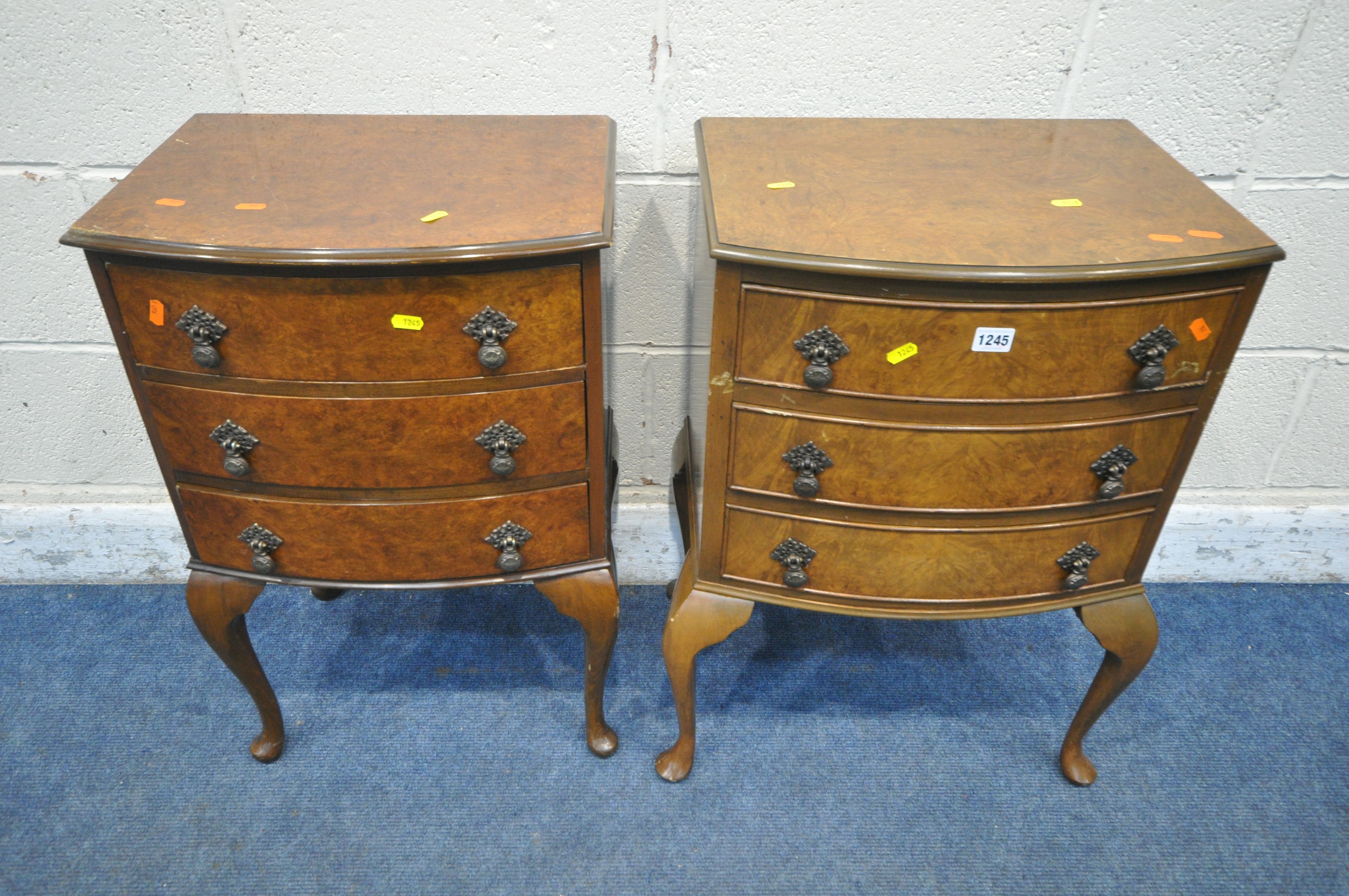 TWO BURR WALNUT BOW FRONT THREE DRAWER BEDSIDE CHESTS, raised on cabriole legs, largest width 53cm x