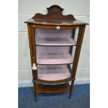 AN EDWARDIAN MAHOGANY BOW FRONT DISPLAY CABINET, with a raised back, the single door enclosing two