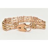 A ROSE METAL GATE BRACELET, three bar fancy gate bracelet, links stamped 9ct, length 180mm, together