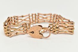 A ROSE METAL GATE BRACELET, three bar fancy gate bracelet, links stamped 9ct, length 180mm, together