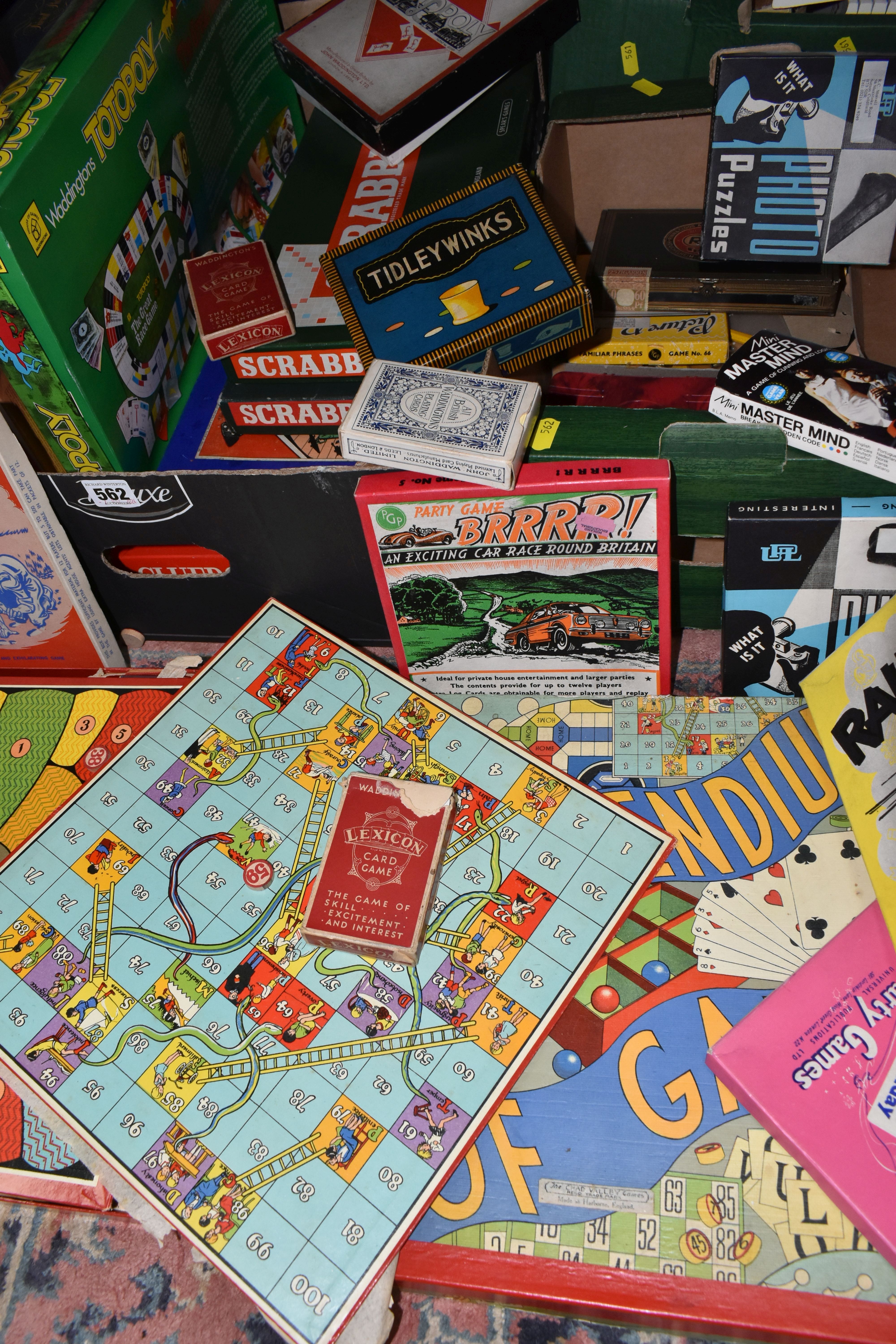 TWO BOXES OF BOARD GAMES AND PLAYING CARDS, to include two sets of Scrabble, a Monopoly board,