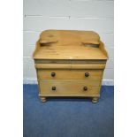 A 19TH CENTURY PINE WASHSTAND, the raised back fitted with two shelves, the base with two short over