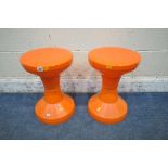 A PAIR OF DANISH ORANGE PLASTIC TAM TAM STYLE STOOLS, each stool separates in the centre, possibly