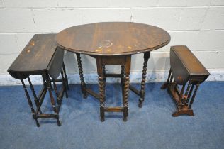 THREE EARLY 20TH CENTURY OAK DROP LEAF TABLES, the largest raised on barley twist supports, the