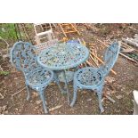 A CAST ALUMINIUM GARDEN TABLE 67cm in diameter, and a pair of matching chairs with grape and vine
